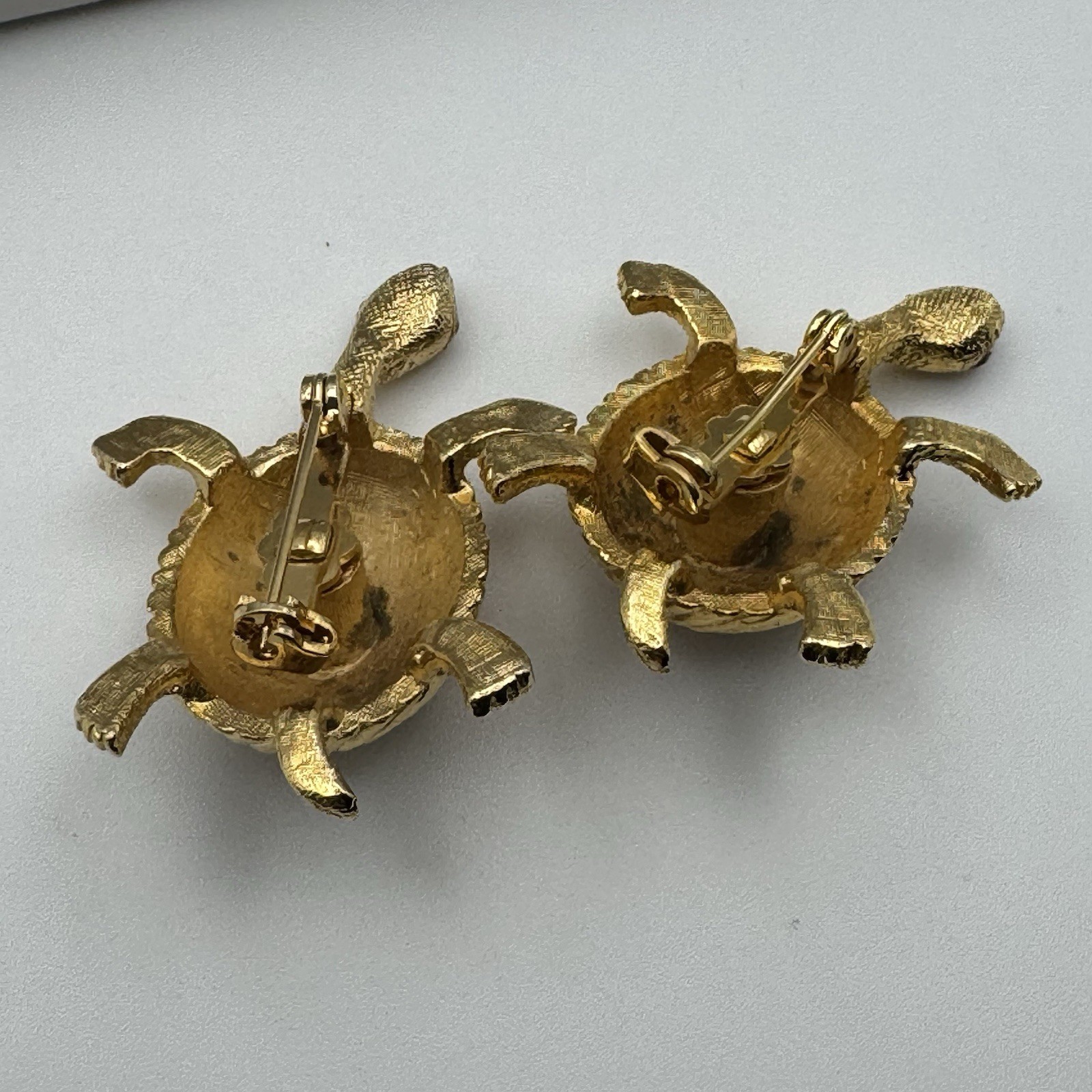 Goldtone Textured Twin Turtle Brooches Red Rhinestone Eyes