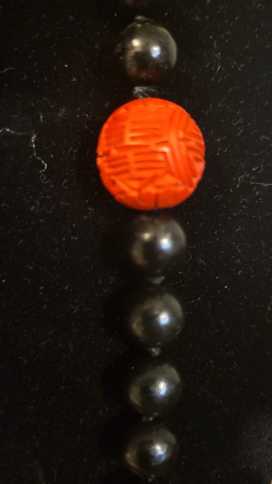 Cinnabar and black obsidion necklase 30″ hand knotted no clasp. 11 carved red lg