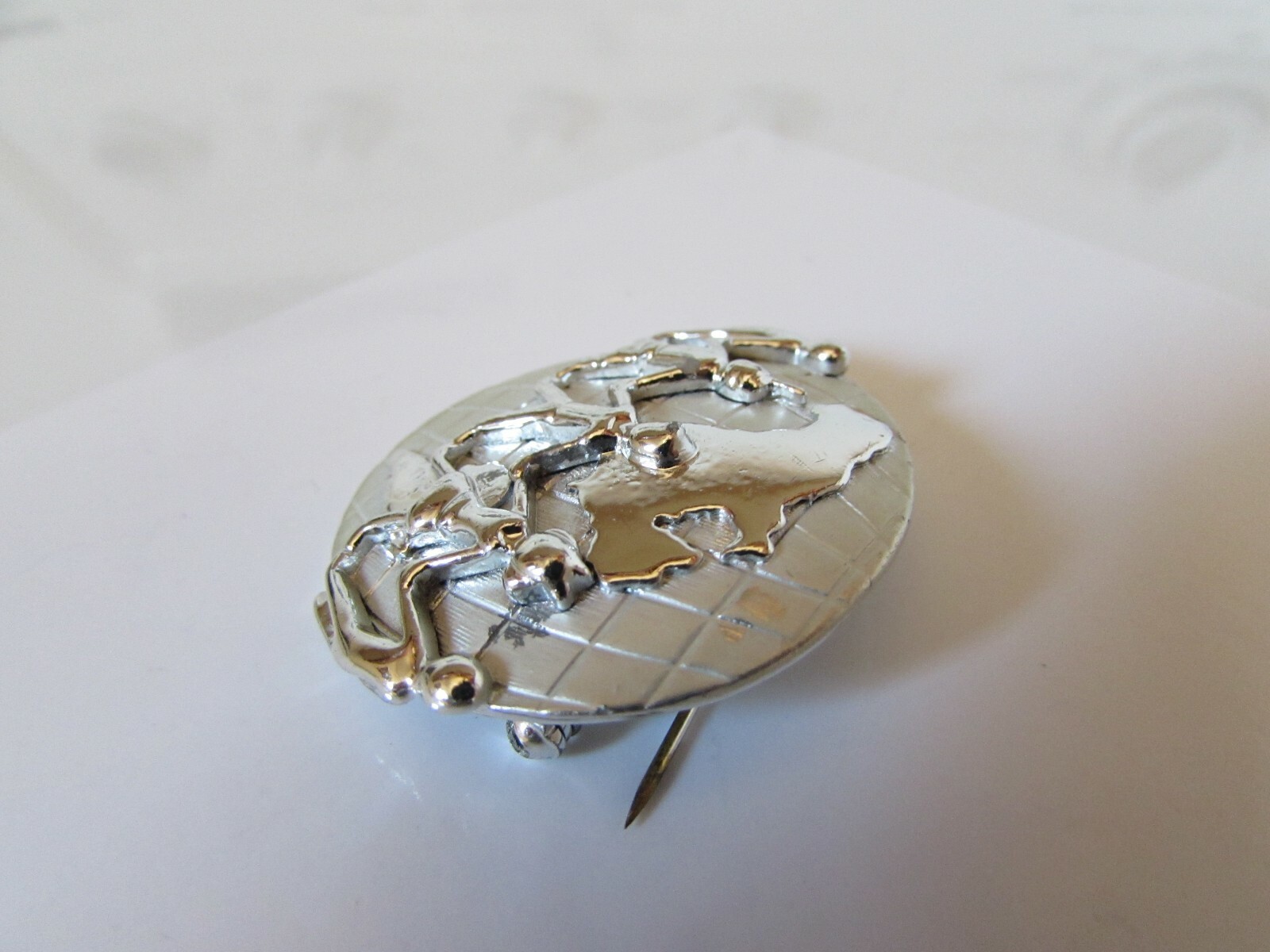 Vintage AJC Signed Silver Tone Holding Hands Across the World Brooch Pin 1 1/2″