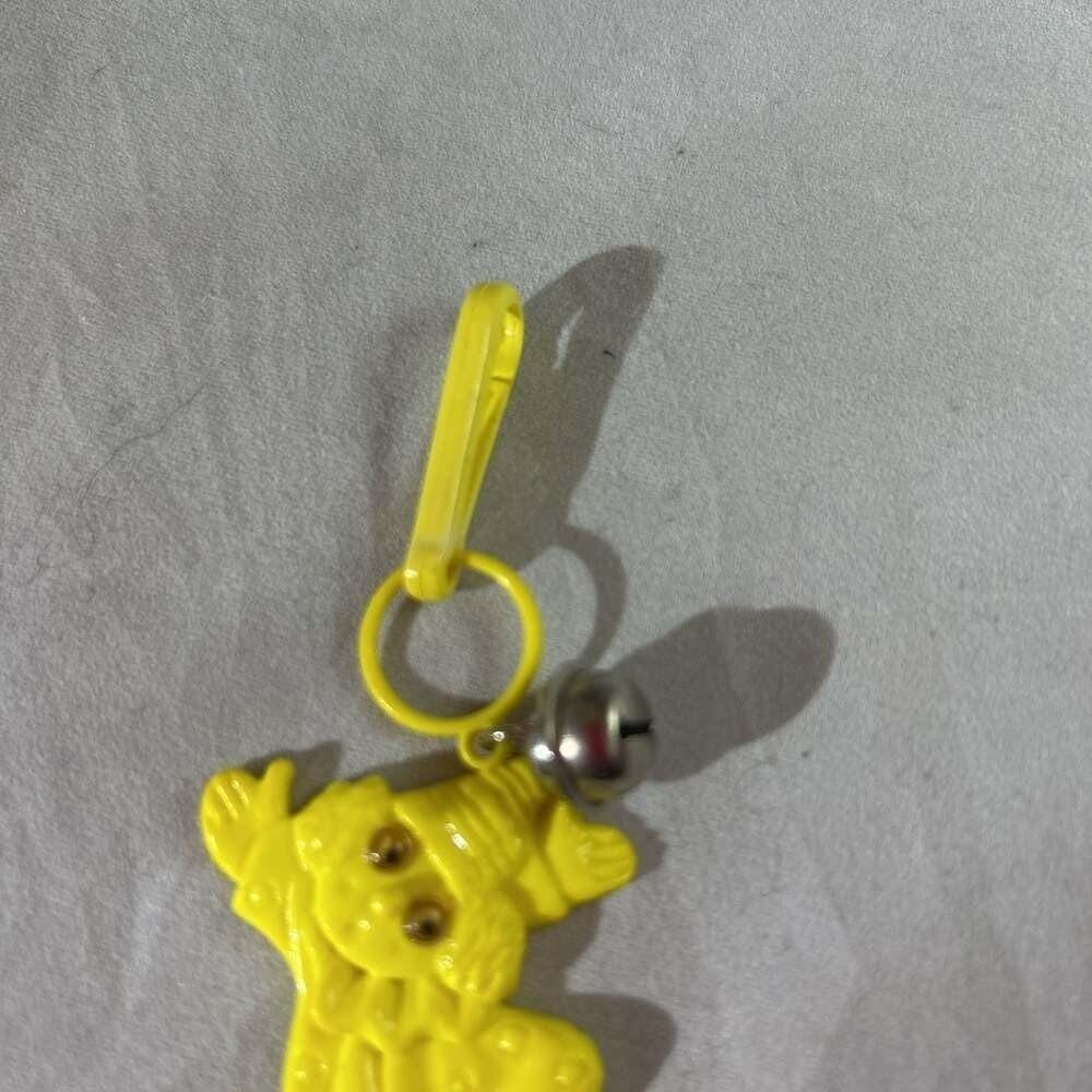 Vintage 1980s Plastic Bell Charm Yellow clown Googly Eyes Clip-on Toy