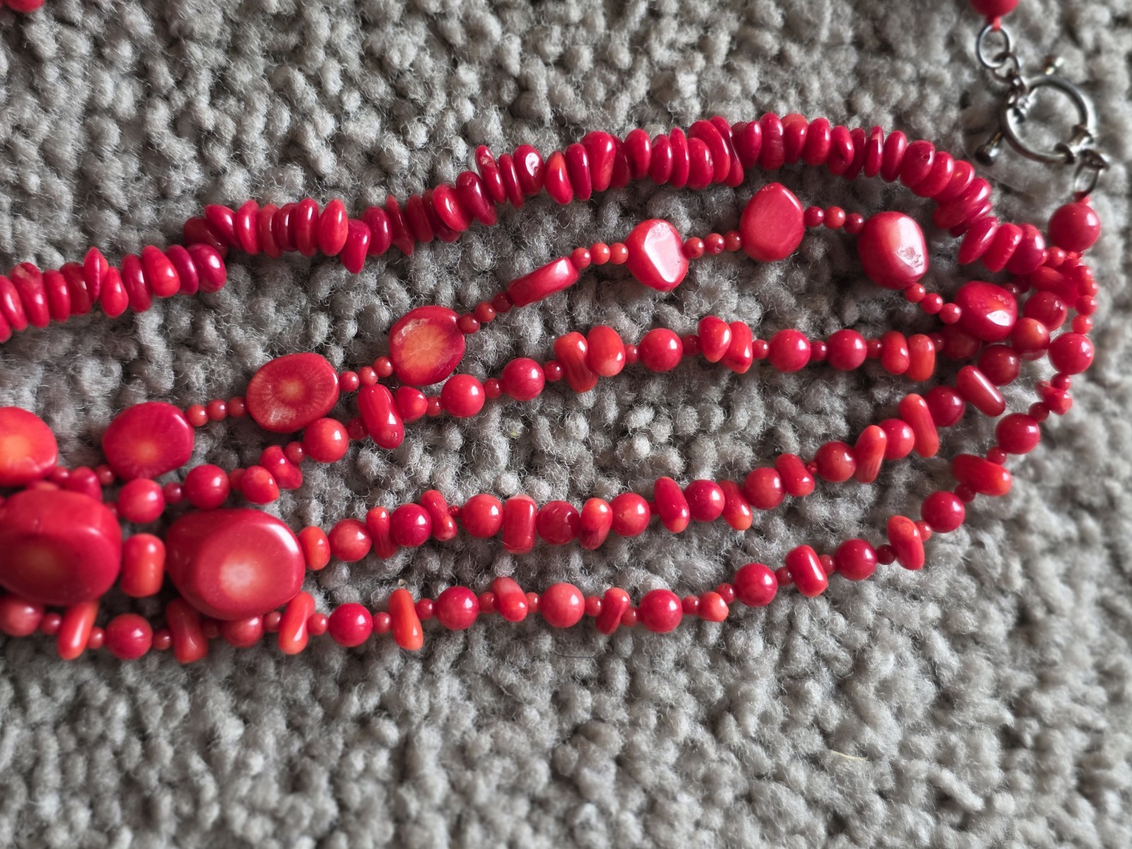 multi-strand red coral bead necklace Different shapes and sizes.