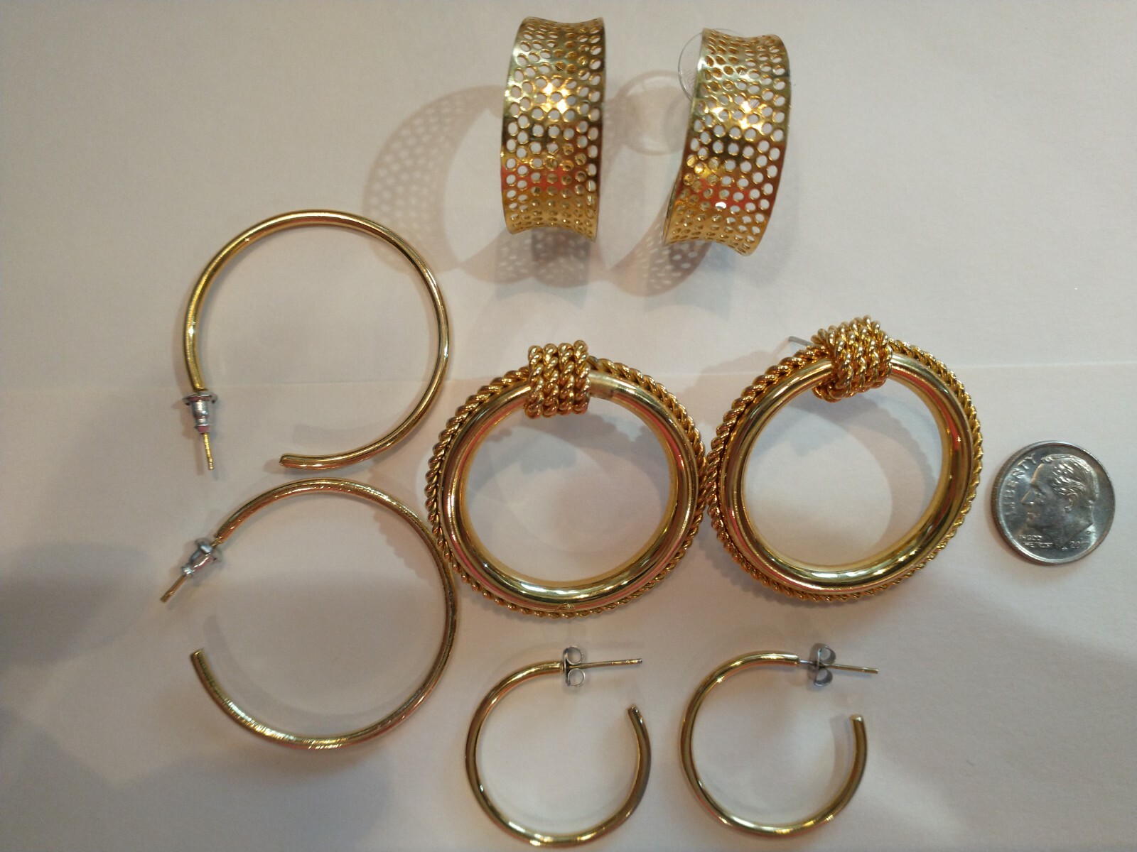 Four pair gold hoops different sizes and shapes pierced