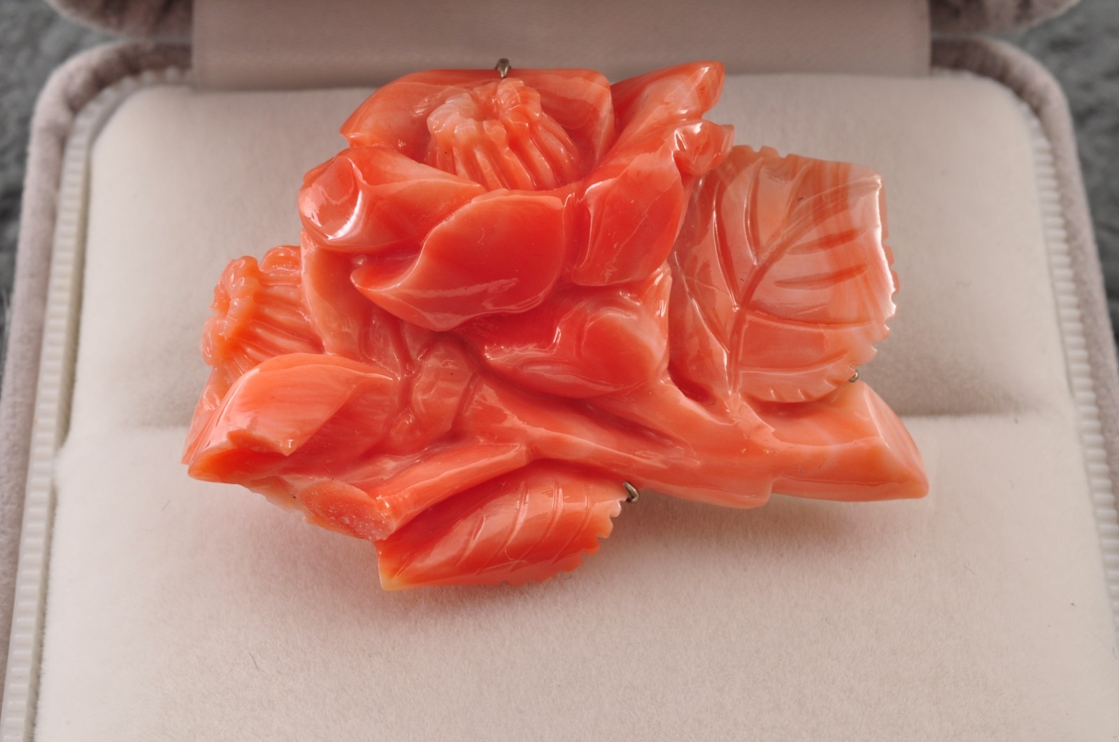 Pink coral OBIDOME, carved “camellia” (38mm (1.49in) total 50.0ct) Certificate.
