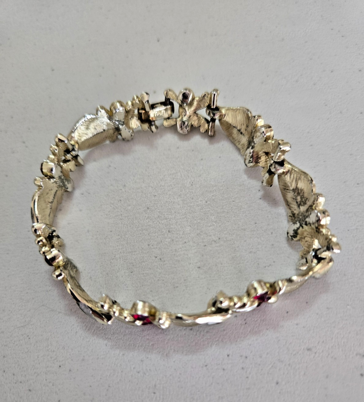 Vintage STAR Bracelet. Signed. Goldtone Setting with Red Rhinestone Accents.