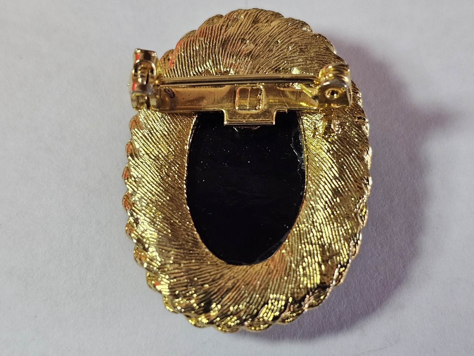 Oval Cameo Brooch Pin, Gold Tone Rope Frame, White Portrait on Black Background