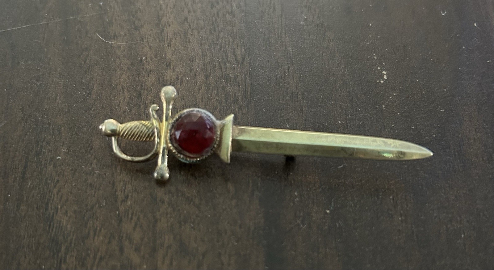 Vintage Brass Tone Sword Pin Red Round Bezel Stone Signed Broadcast
