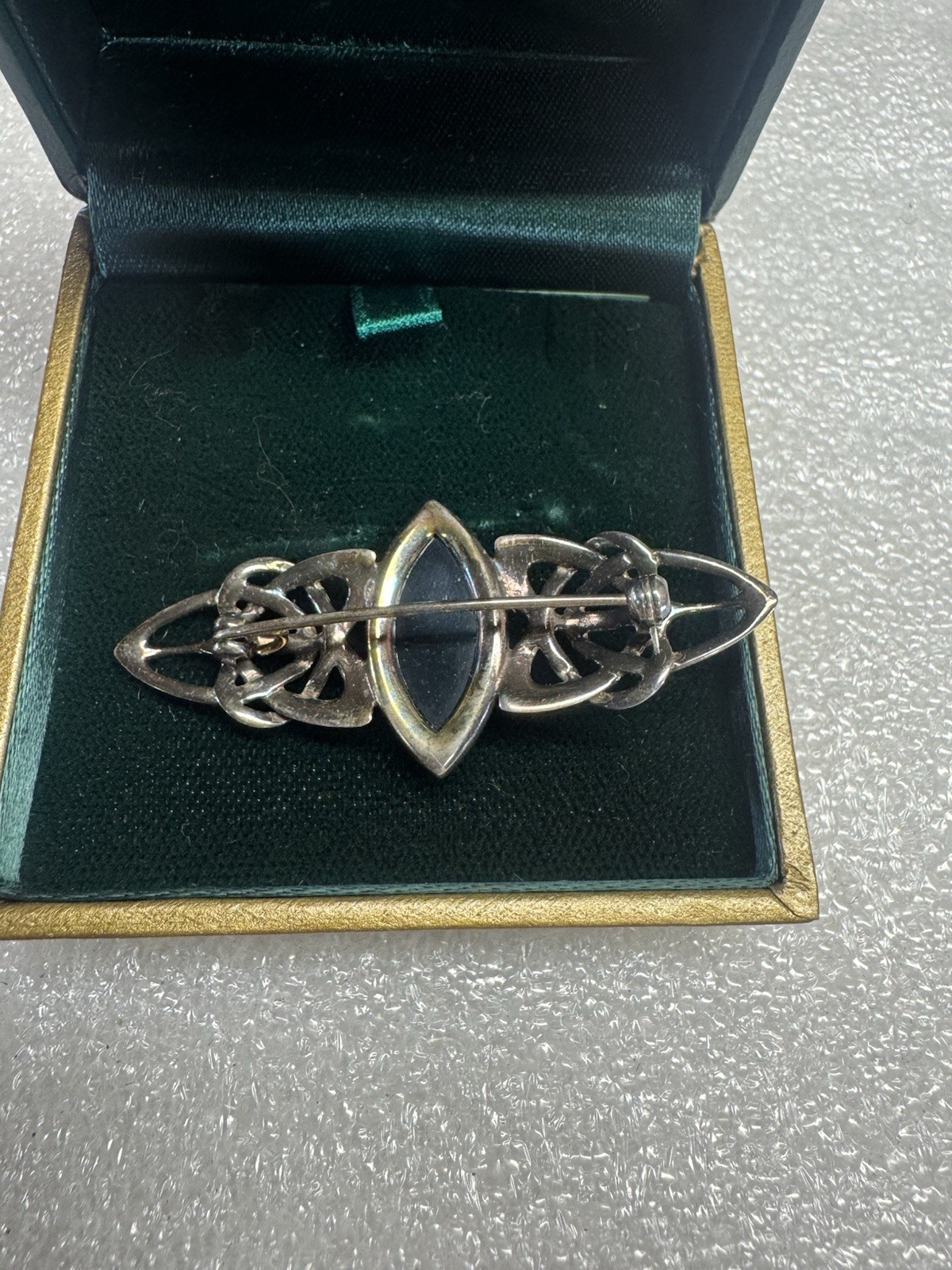 Kit Heath sterling silver brooch features a marquise-cut amber stone