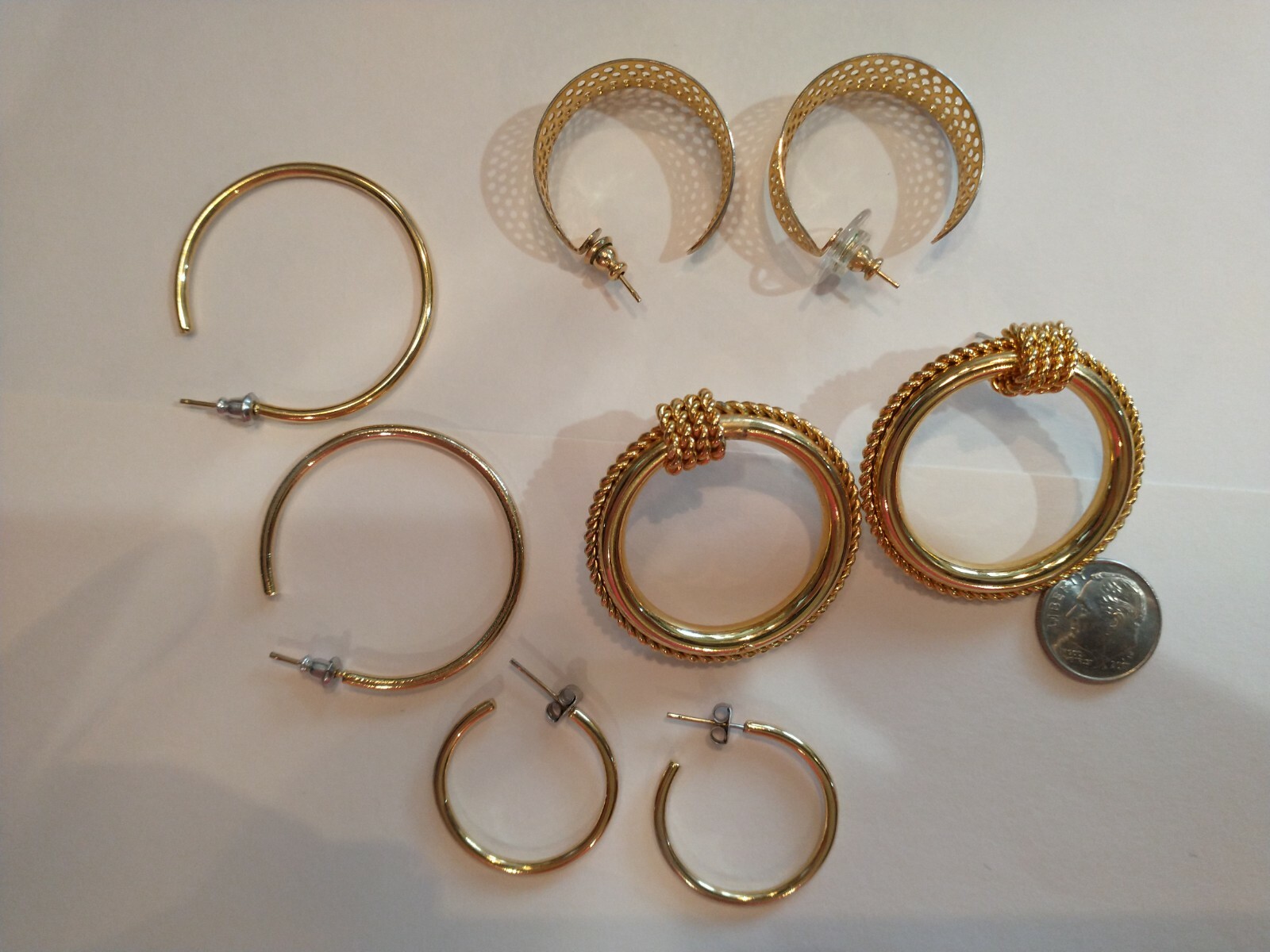 Four pair gold hoops different sizes and shapes pierced