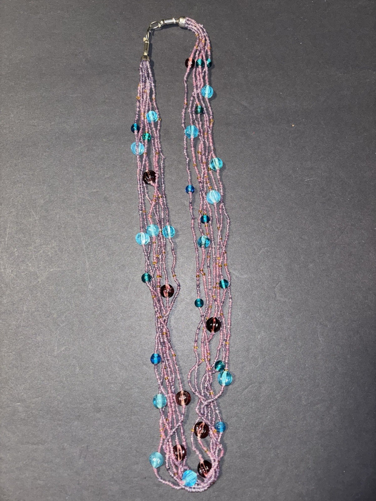 Gorgeous multi-strand necklace made of purple and blue glass seed beads.