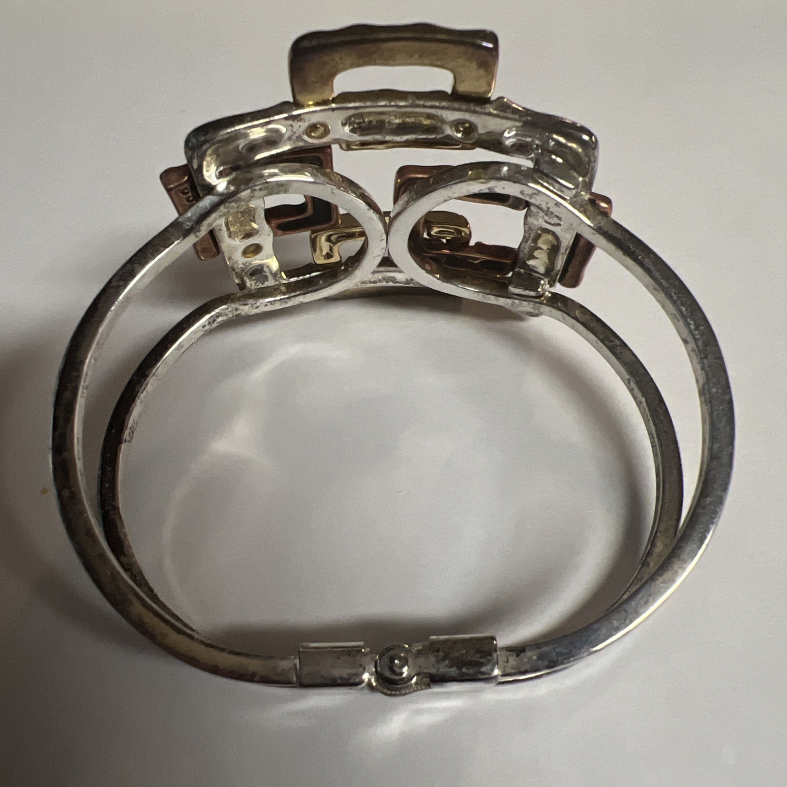 Brutalist mixed metal cuff bracelet, geometric silver and gold tone squares.