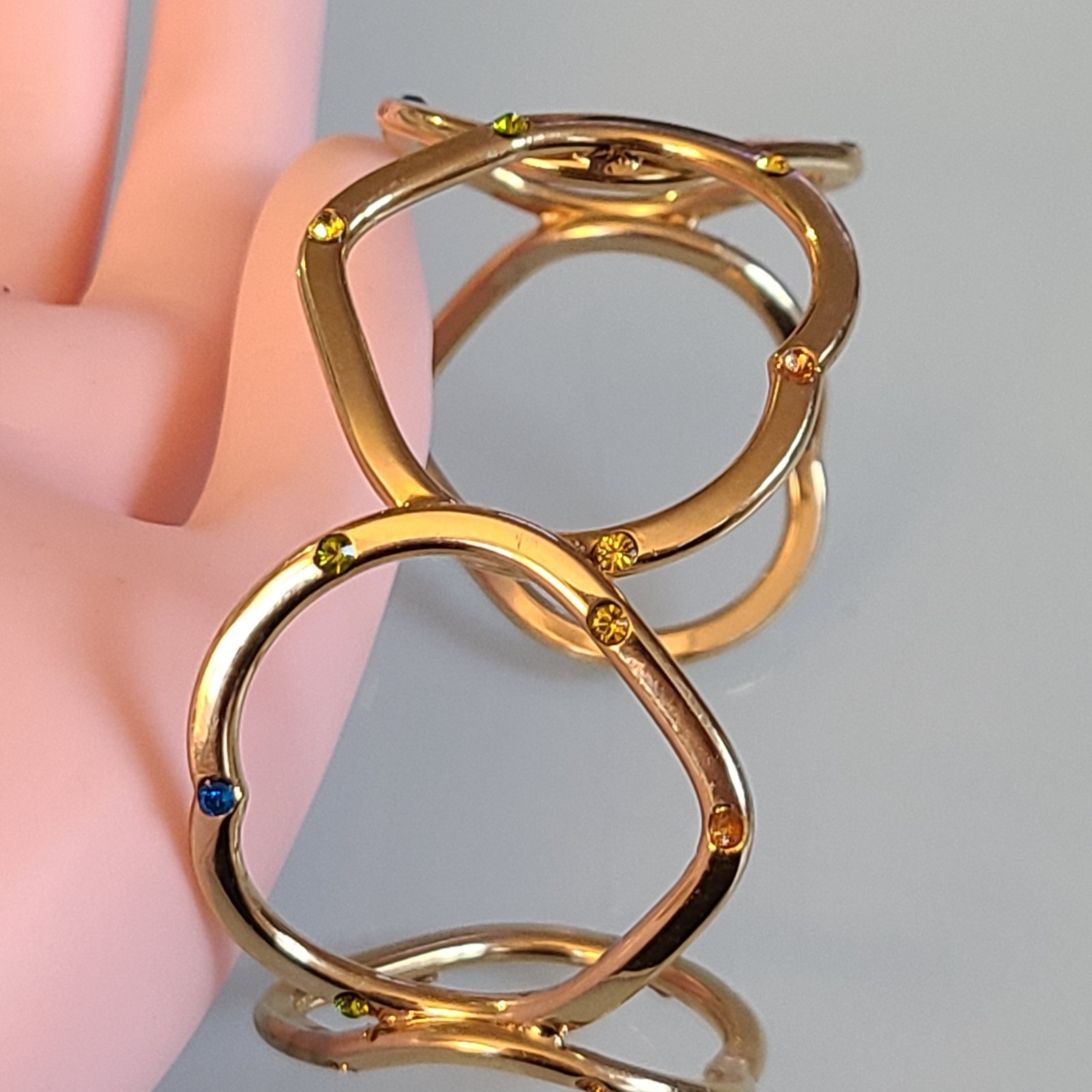 Gold-Tone Open Heart Hinged Cuff Bracelet with Multi-Color Rhinestones.