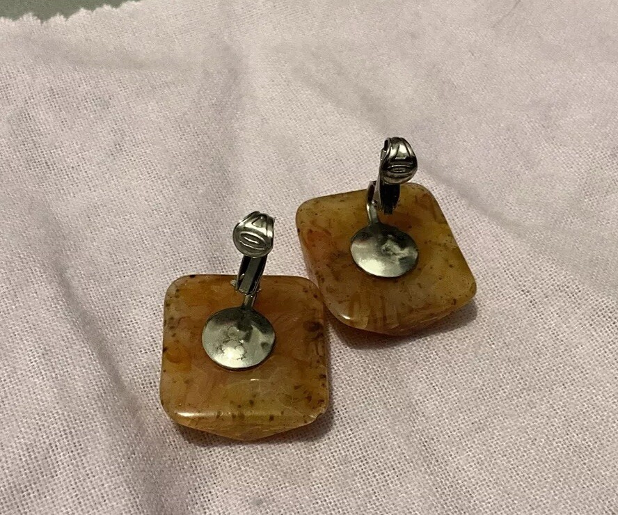 Bakelite Carved Apple Juice Clip On Earings About I 1/4 Inch Across 3/8 Thick.