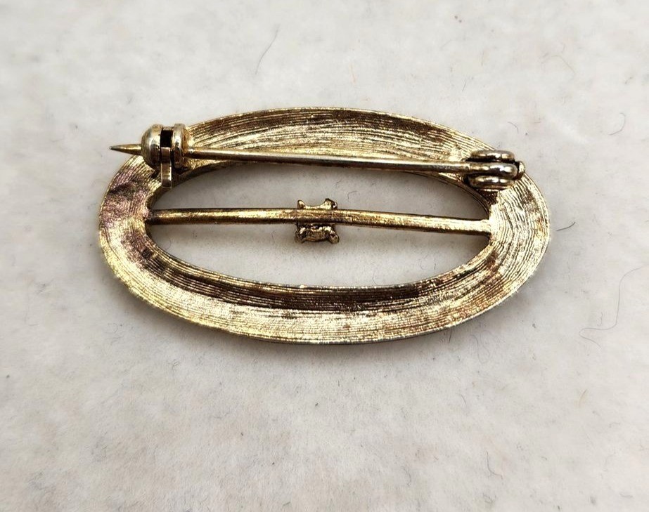 Vintage Gold-Tone Oval Brooch With Intricate Scroll Design & Clear Rhinestone Ac
