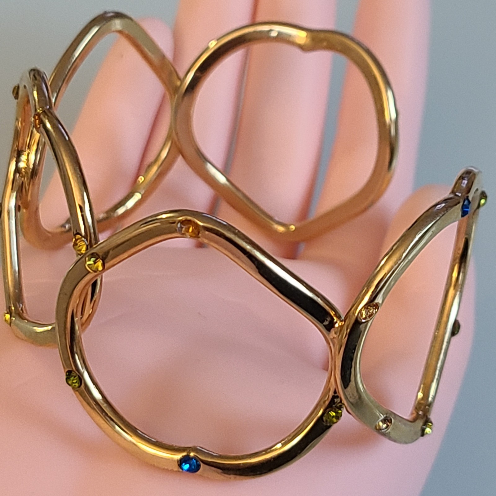 Gold-Tone Open Heart Hinged Cuff Bracelet with Multi-Color Rhinestones.