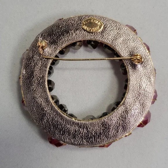 Ali Khan sparkling circular brooch, with faceted stones fuchsia/red-charcoal/blk