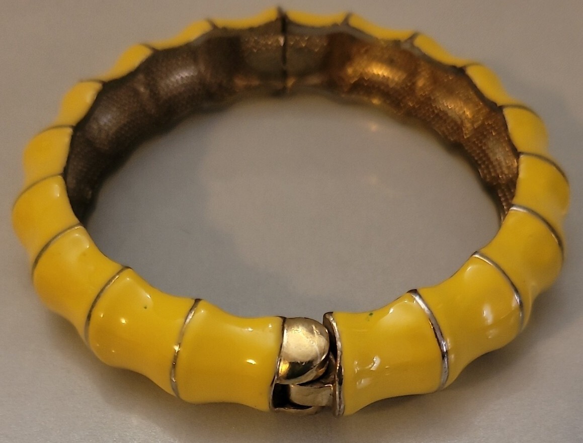 Hinged clamper Yellow bracelet on shapely goldton jewelry