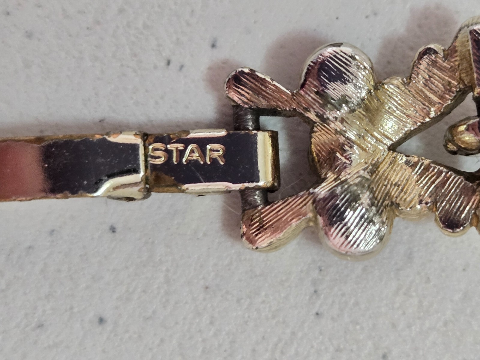 Vintage STAR Bracelet. Signed. Goldtone Setting with Red Rhinestone Accents.