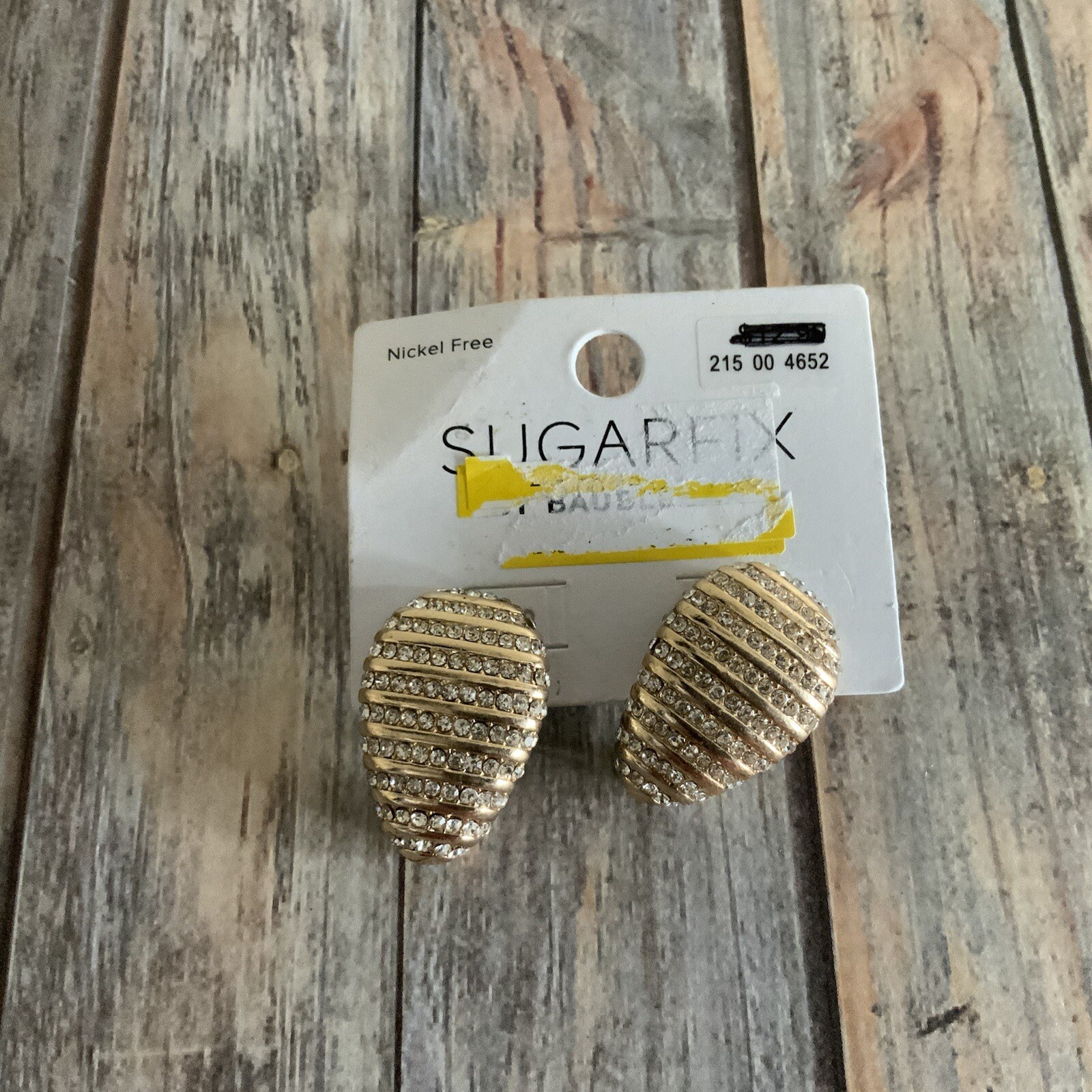 Signed sugarfix rhinestone egg shaped pierced earrings in gold tone