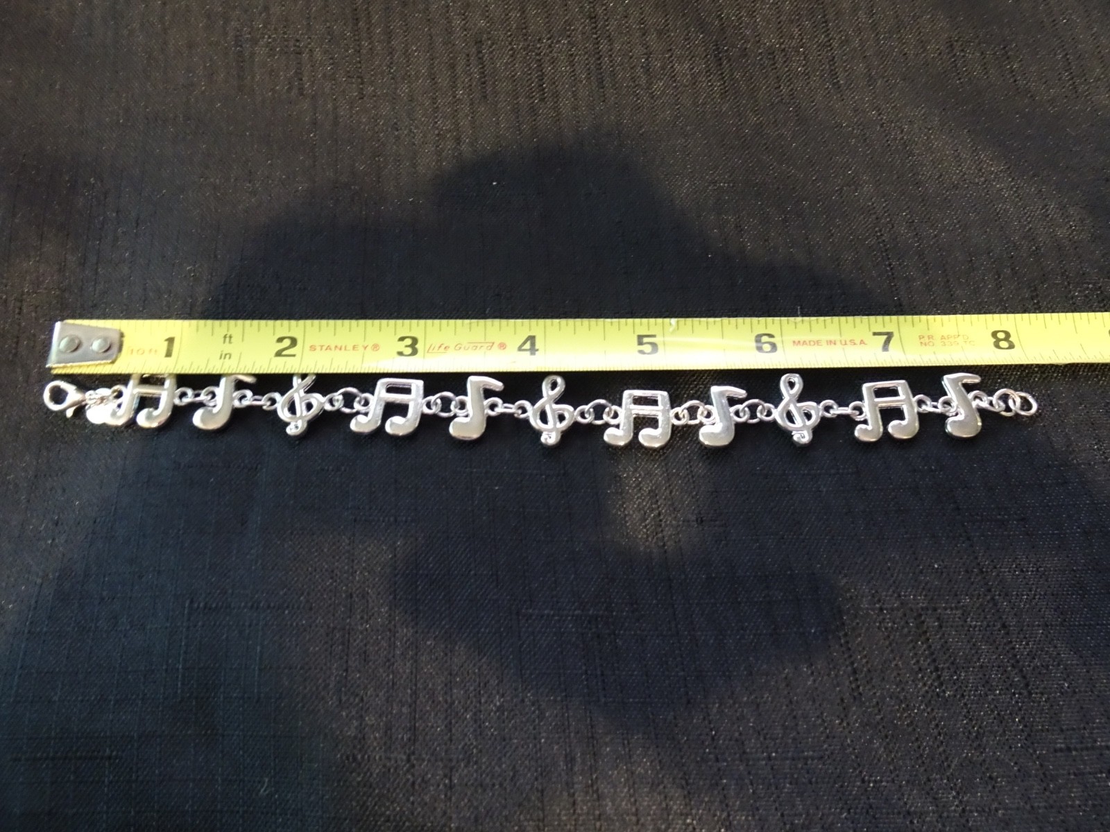 # 484–MUSICL NOTES STERLING SILVER CHARM BRACELET–925–VERY NICE