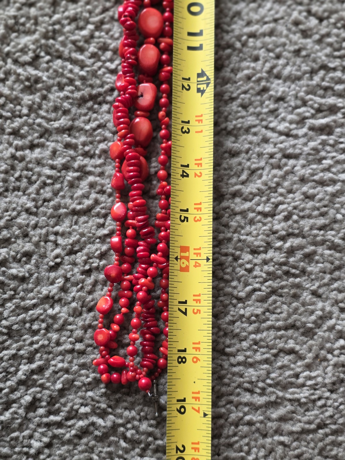 multi-strand red coral bead necklace Different shapes and sizes.
