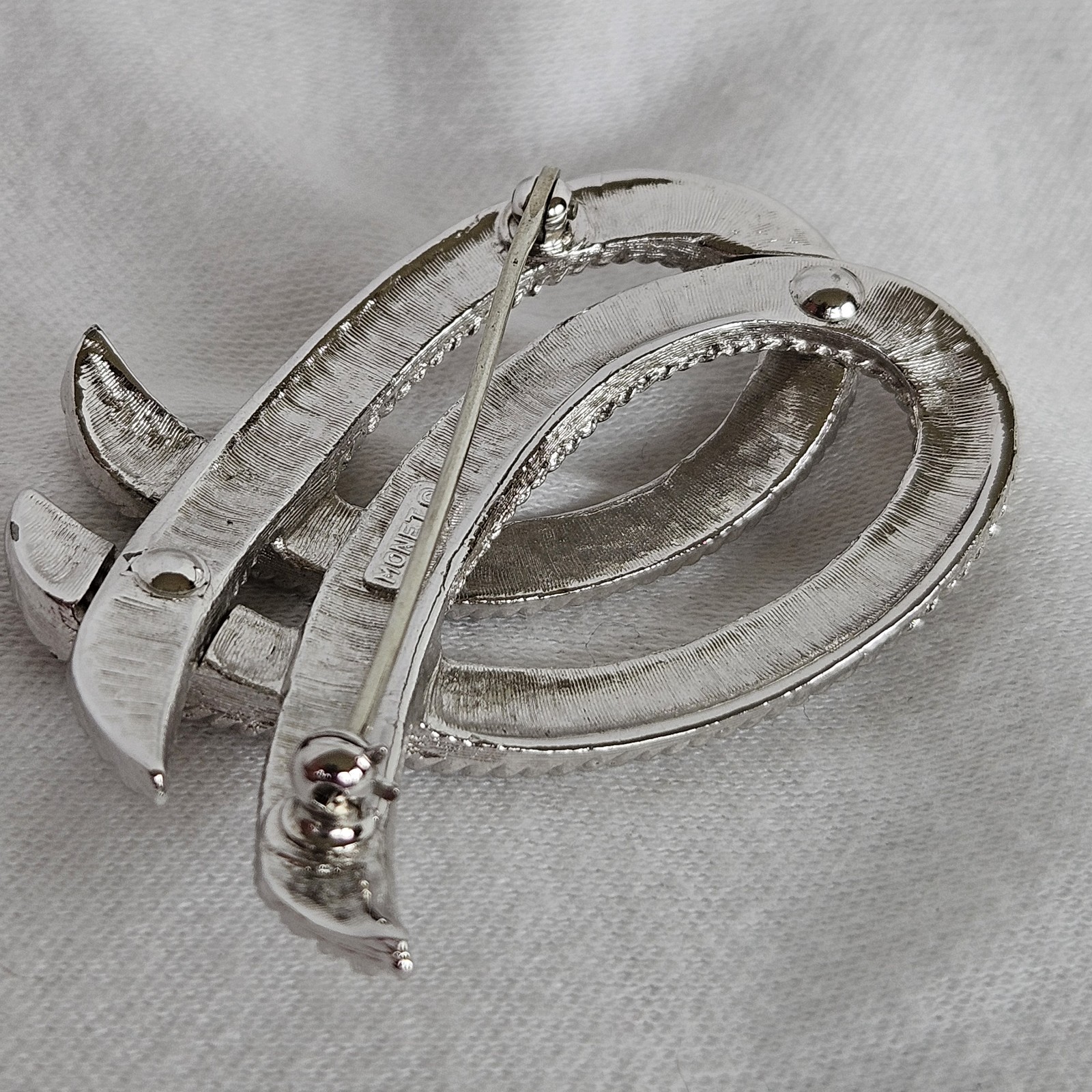 Vintage Monet Silvertone TEXTURED Twisted Ribbon Brooch approximately 2-1/8”