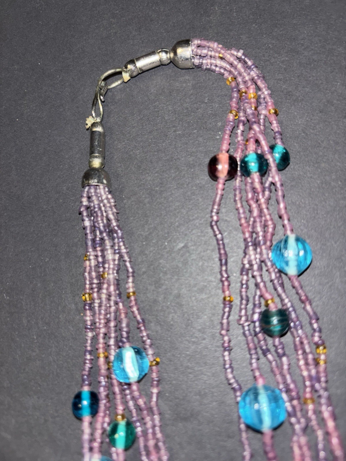 Gorgeous multi-strand necklace made of purple and blue glass seed beads.