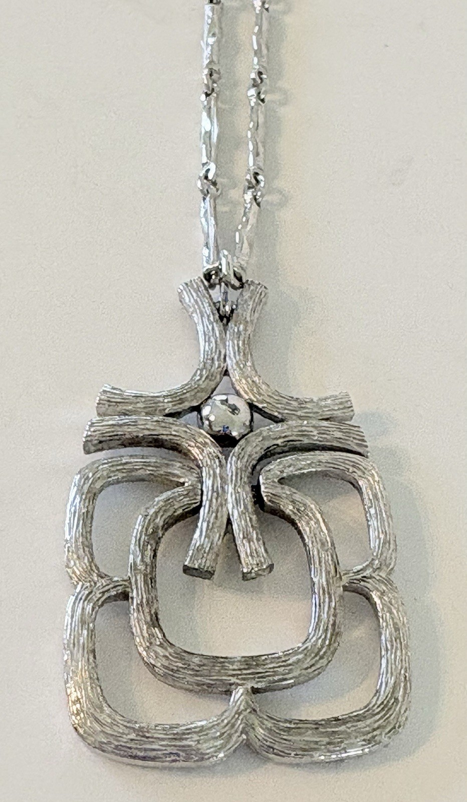 Vintage AVON Textured Silver Tone Articulated Pendant On 24″ Chain