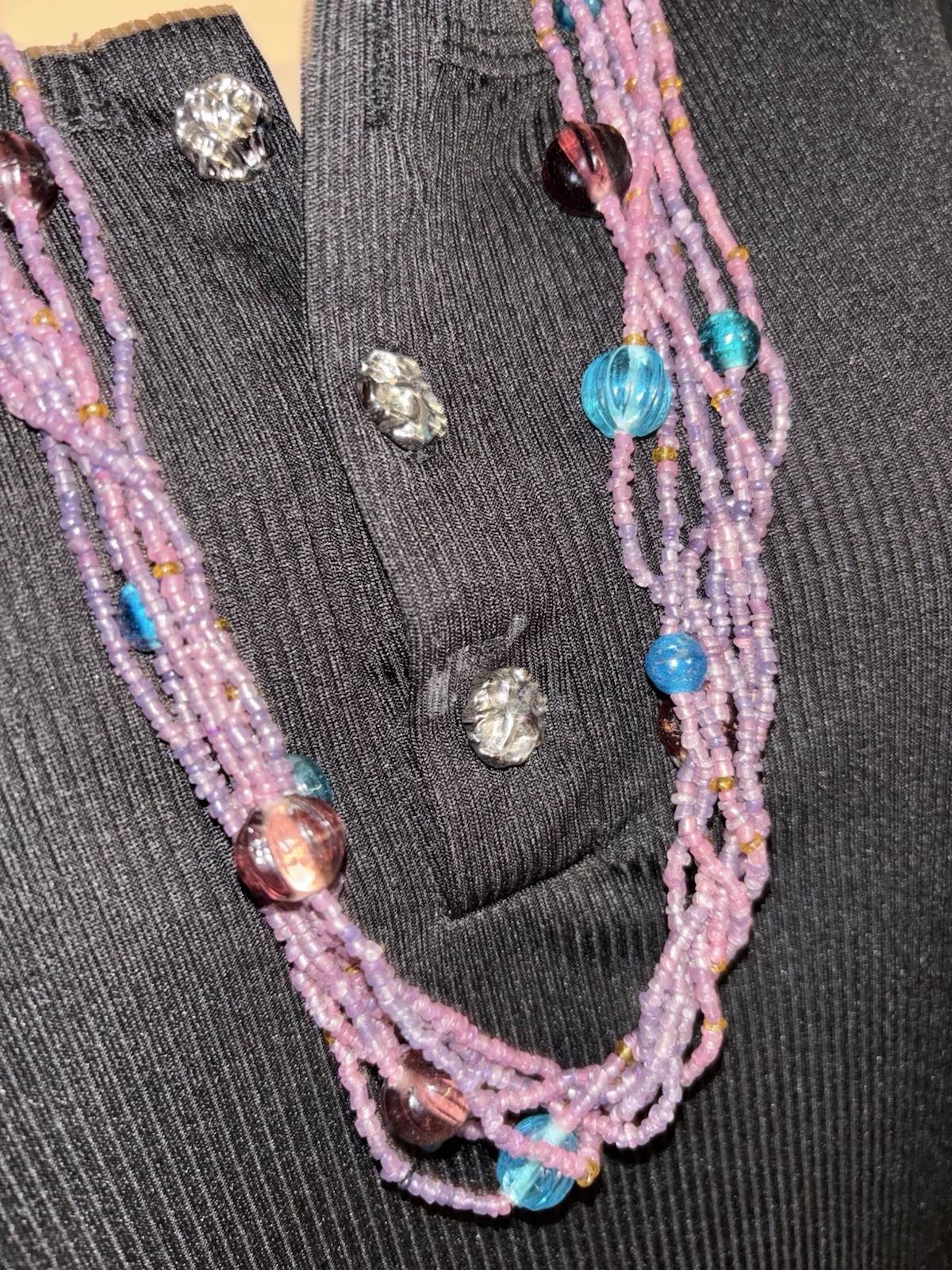 Gorgeous multi-strand necklace made of purple and blue glass seed beads.