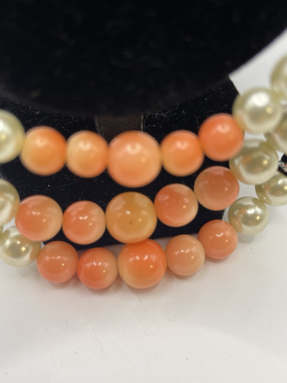 Vintage ivory and coral triple strand pearl necklace with gold tone clasp 20”