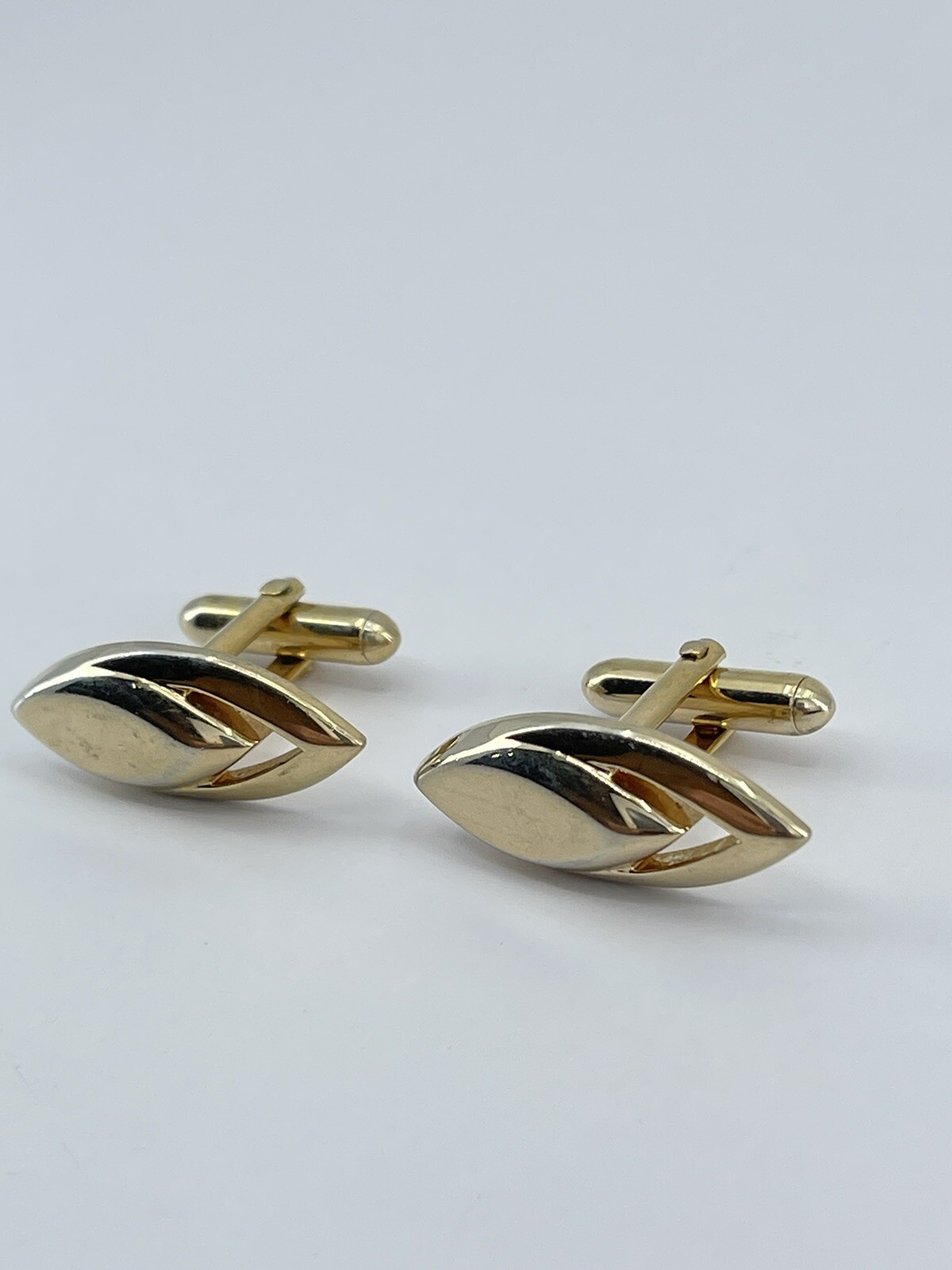 Vintage Swank mens cufflinks torpedo shaped raised cutout design gold tone 3/4″