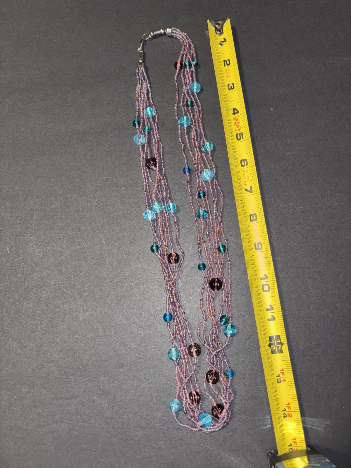 Gorgeous multi-strand necklace made of purple and blue glass seed beads.