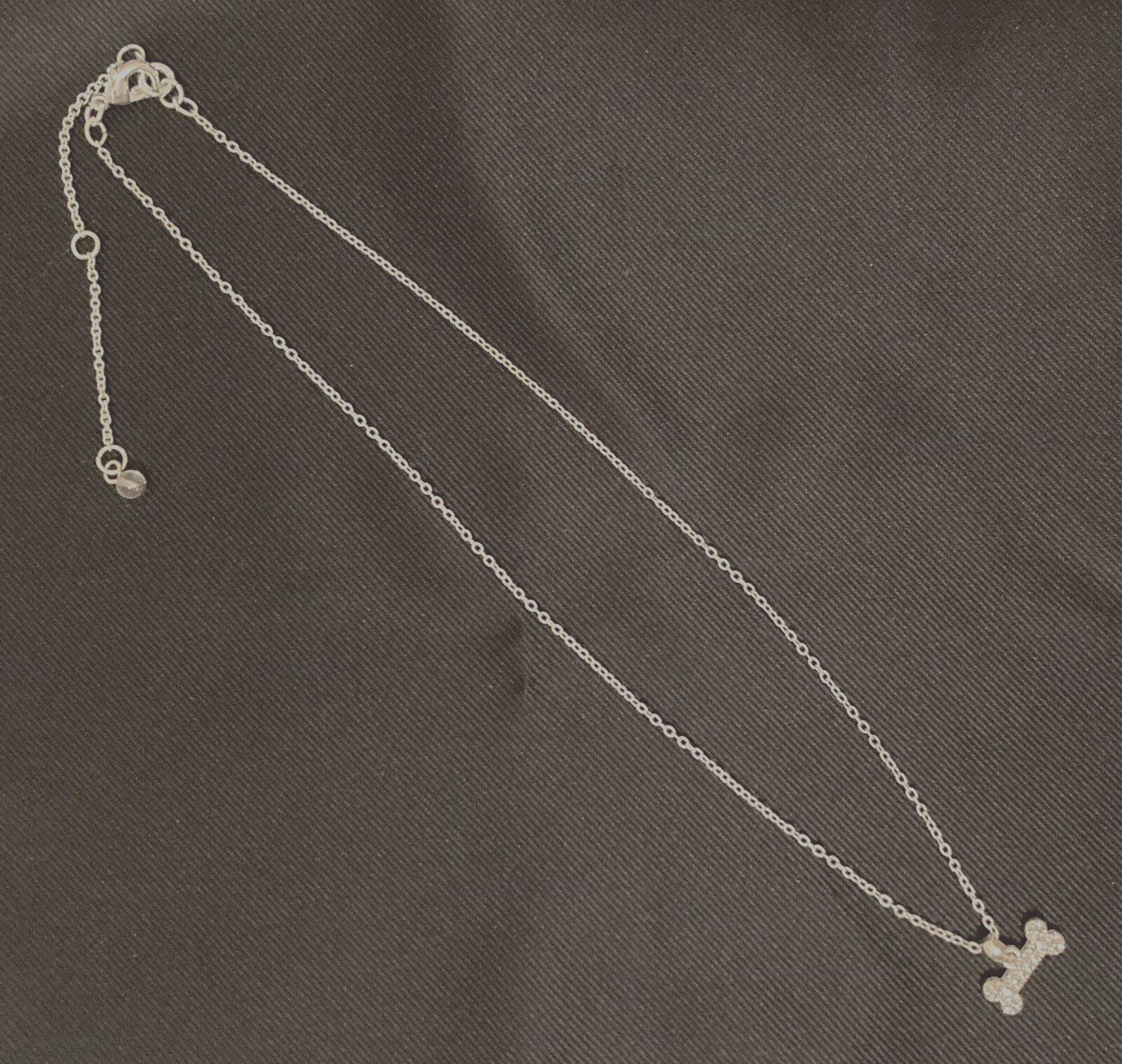 NAPIER Women’s Silver 16″-18″- 20″ Adjustable Necklace w/1/2″ Crystal Dog Bone