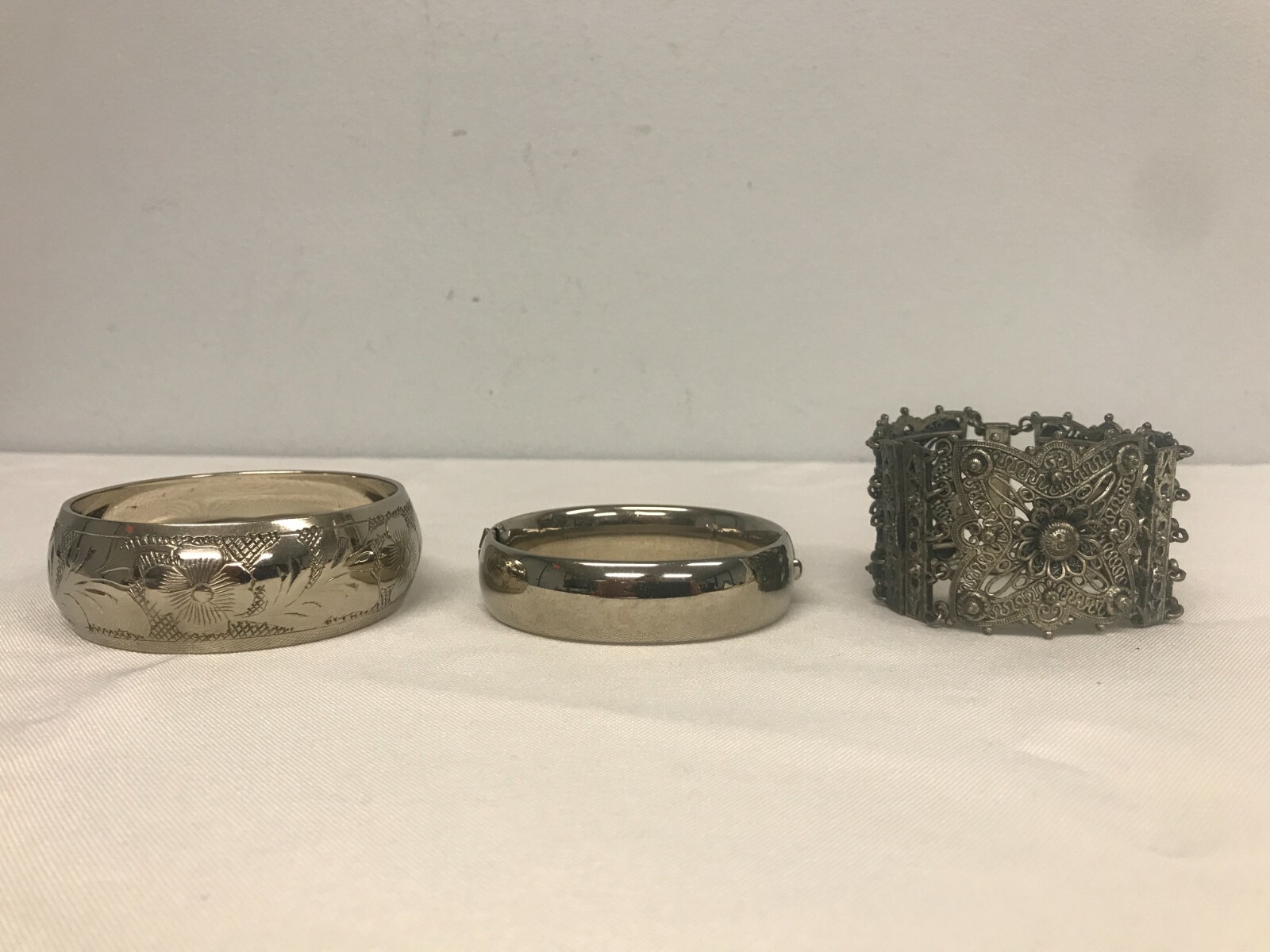 3 VINTAGE SILVERTONE HINGED BANGLE, PIERCED FILLIGREE & ETCHED FLOWER BRACELETS