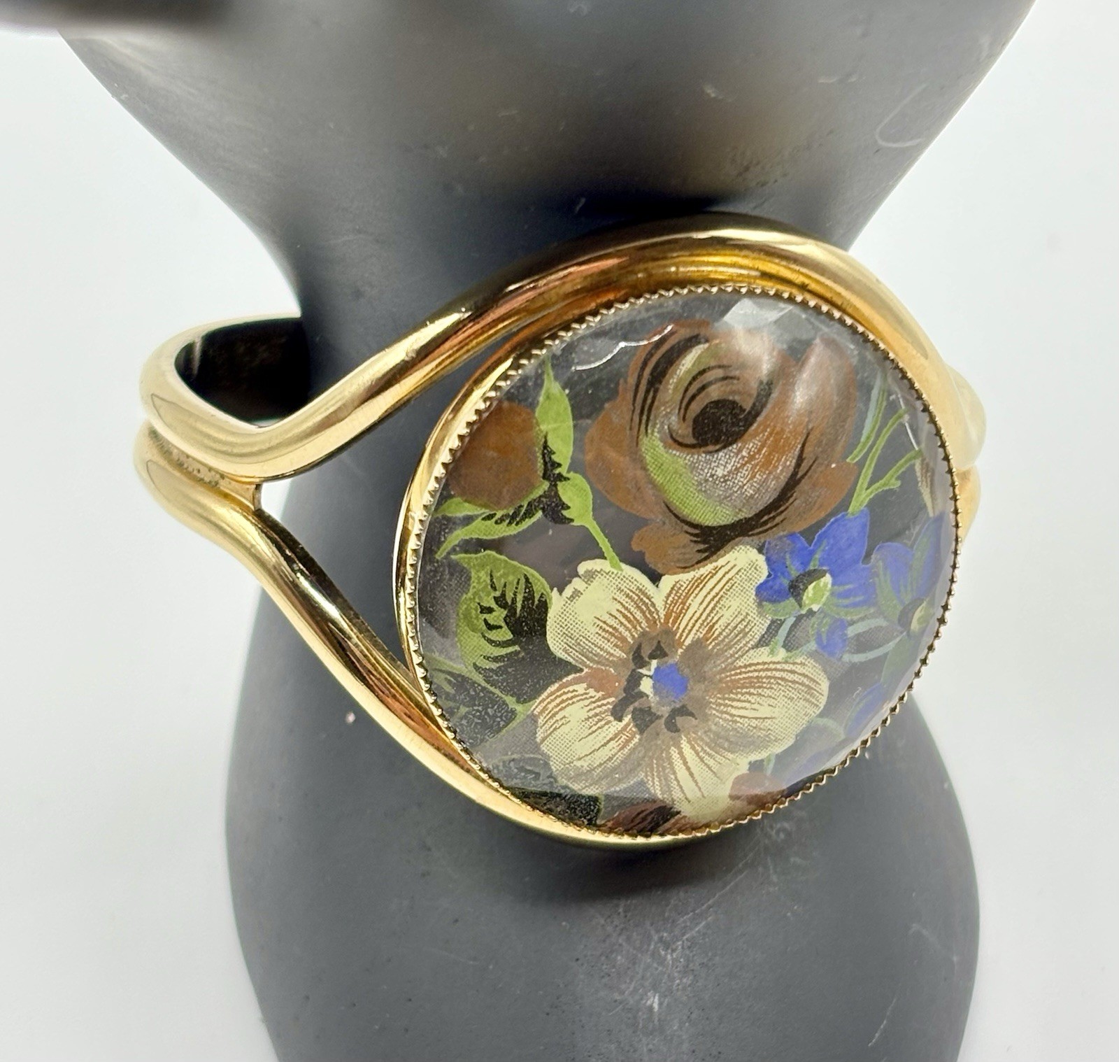 Vintage French flower medallion cuff bracelet gold-toned metal and resin.