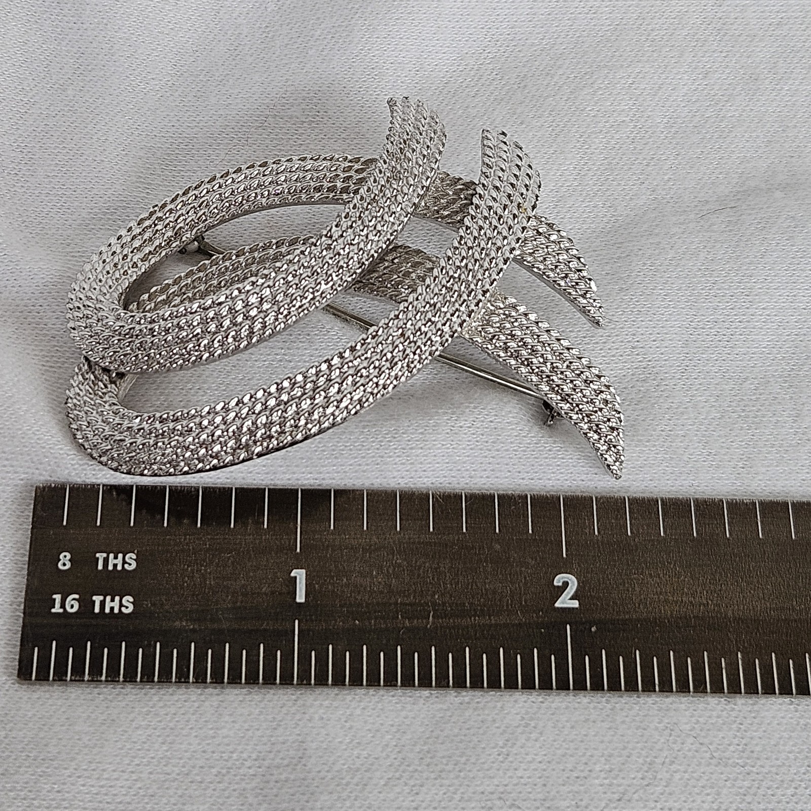 Vintage Monet Silvertone TEXTURED Twisted Ribbon Brooch approximately 2-1/8”