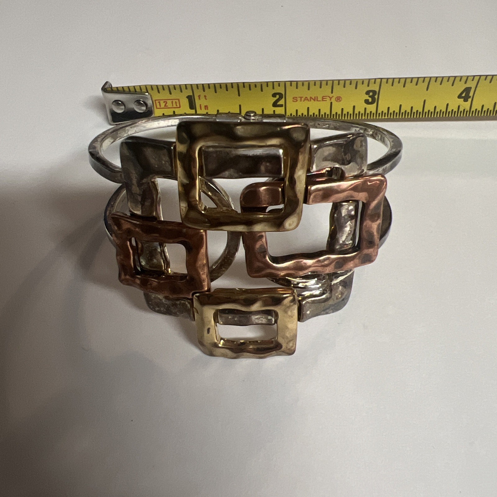 Brutalist mixed metal cuff bracelet, geometric silver and gold tone squares.