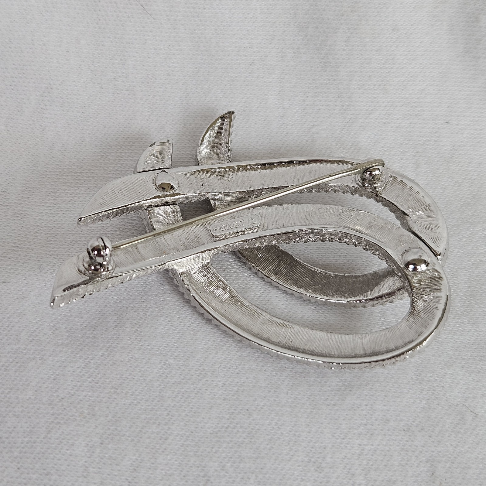 Vintage Monet Silvertone TEXTURED Twisted Ribbon Brooch approximately 2-1/8”