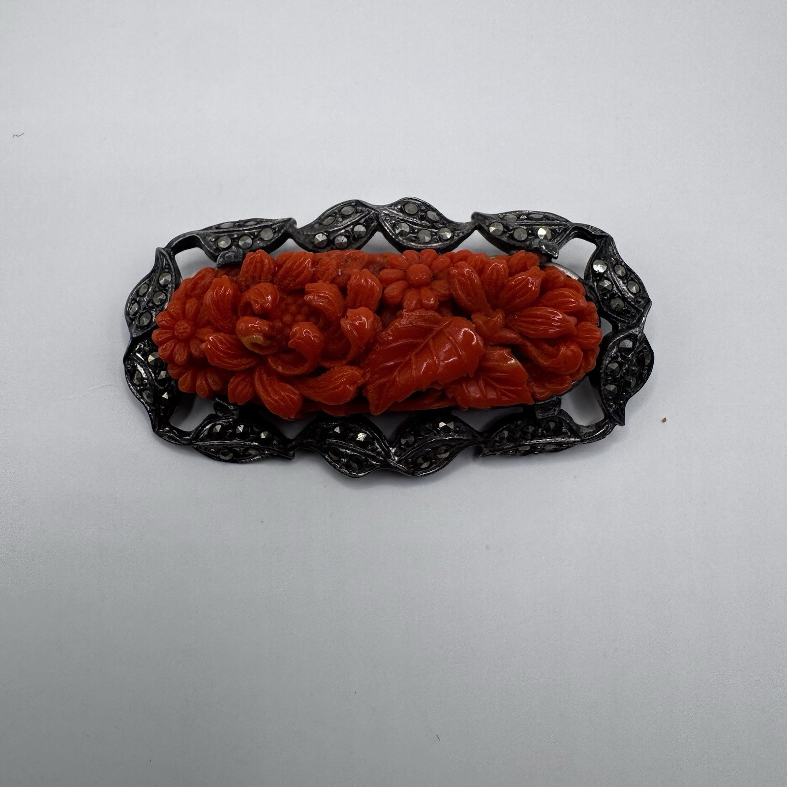 Vintage sterling marcasite coral colored molded peking glass brooch