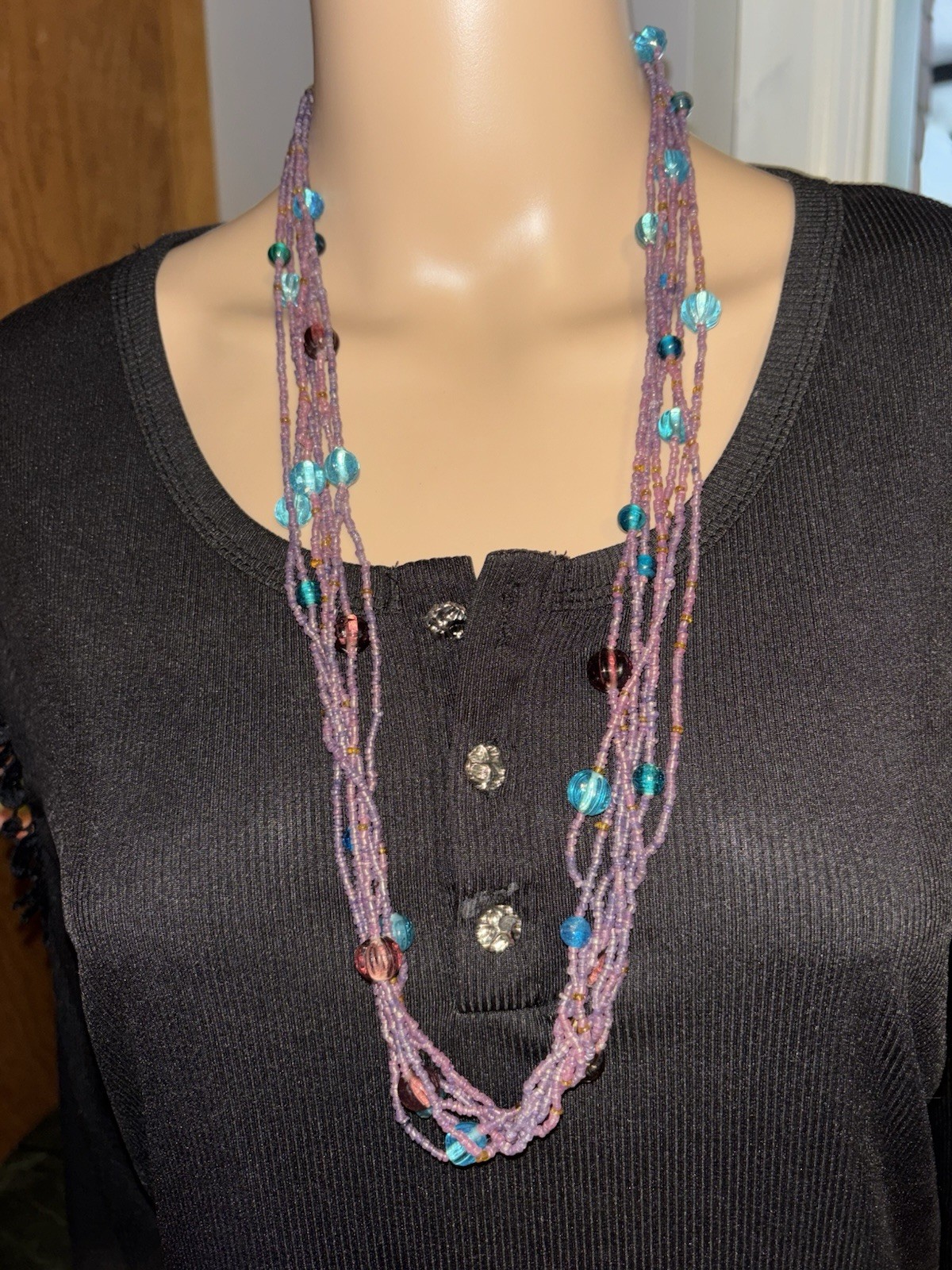 Gorgeous multi-strand necklace made of purple and blue glass seed beads.