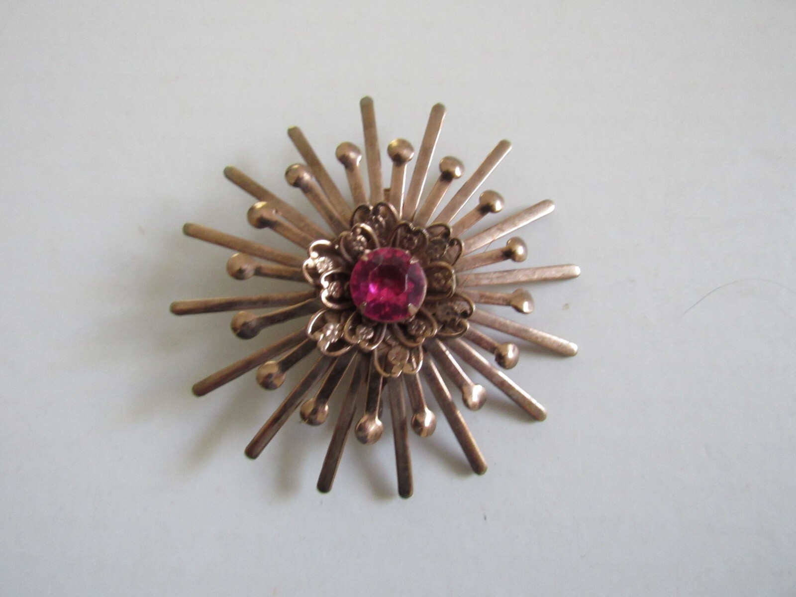 Unbranded Rose Gold Color Starburst Brooch / Pin w Pink Center Stone Vintage