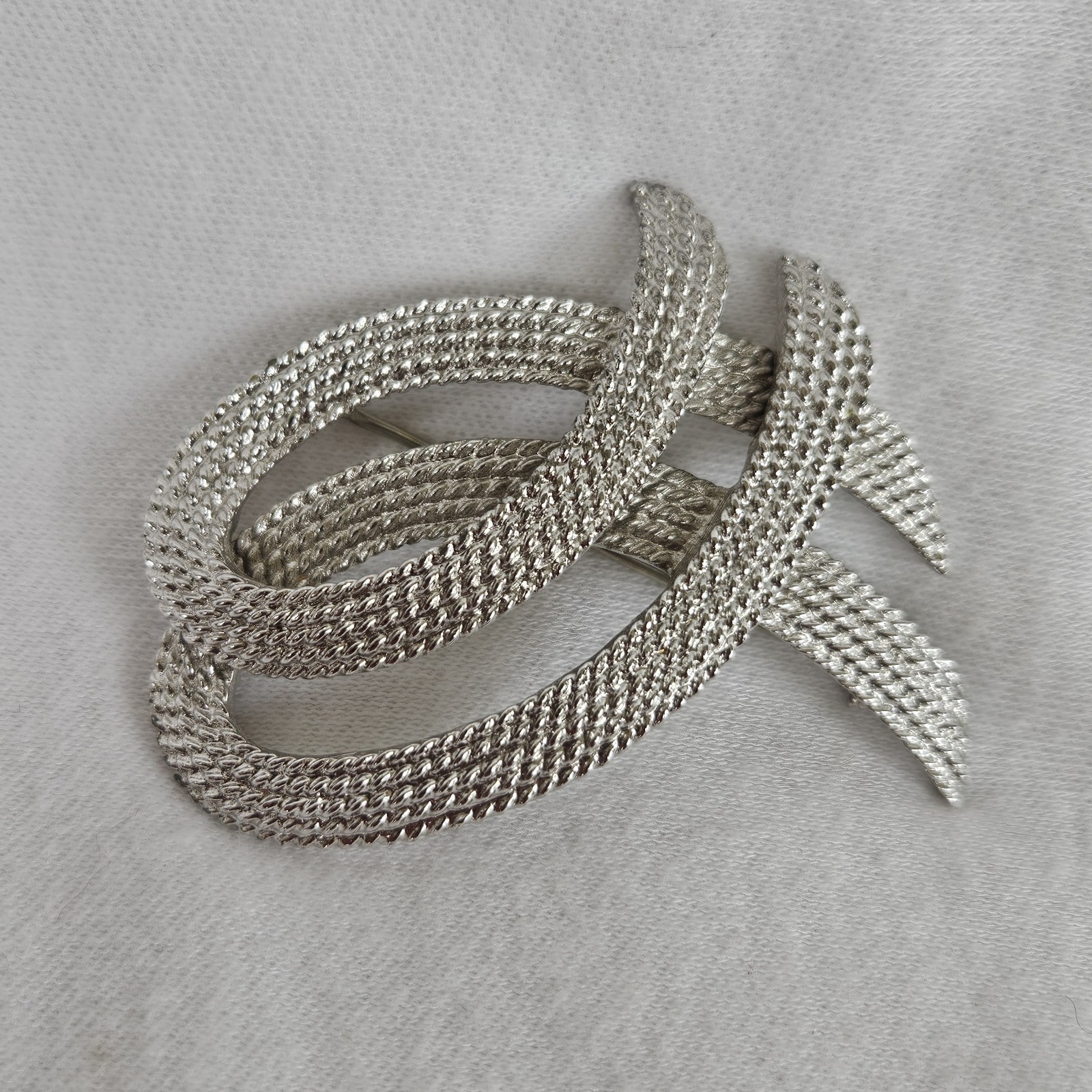 Vintage Monet Silvertone TEXTURED Twisted Ribbon Brooch approximately 2-1/8”