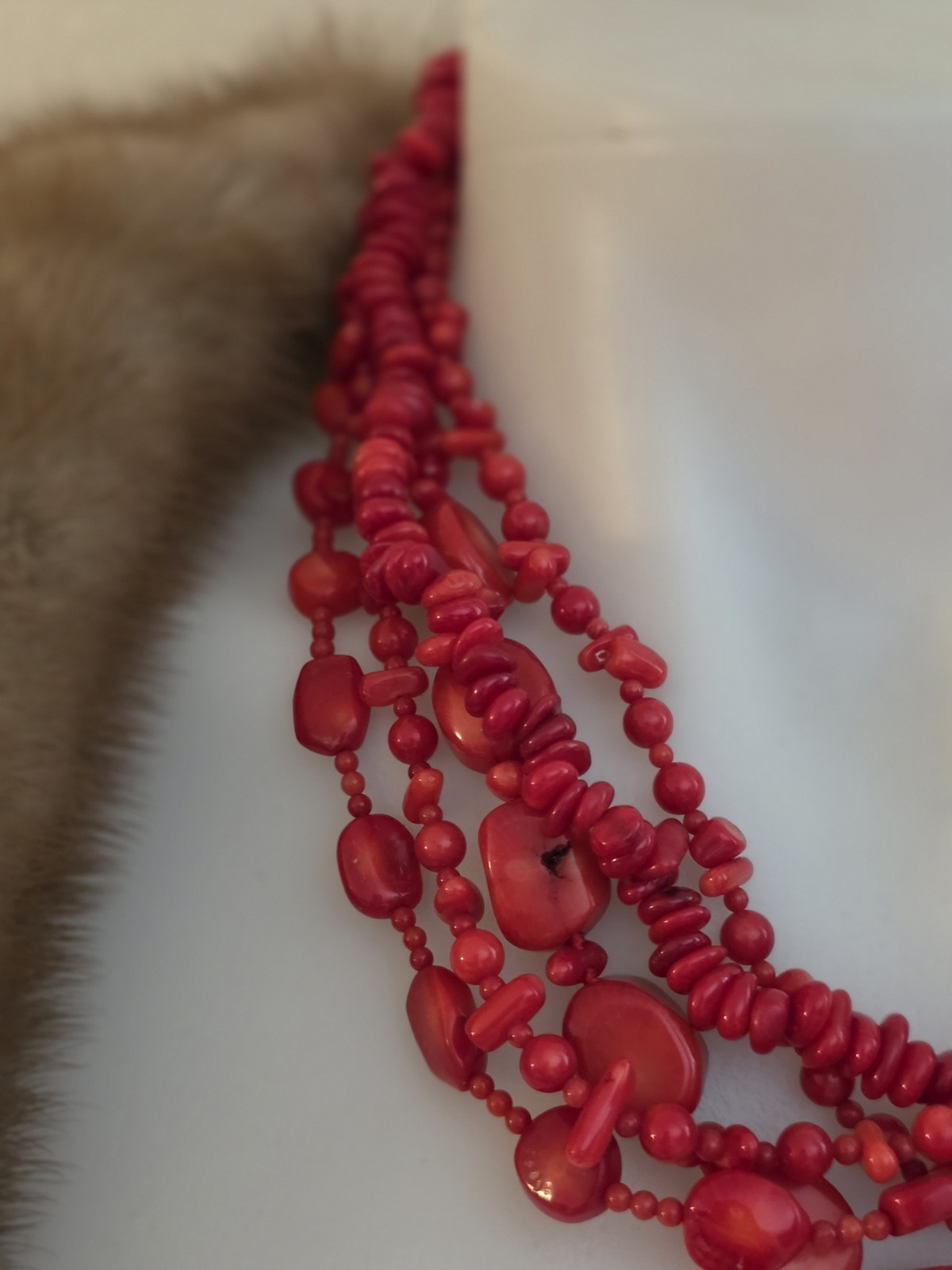 multi-strand red coral bead necklace Different shapes and sizes.