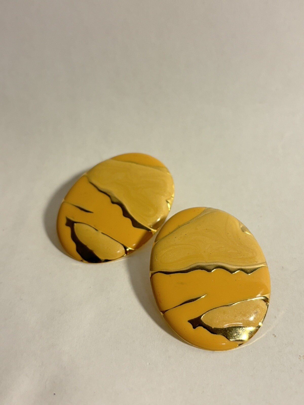 vintage orange and cream tone enamel earrings with gold splash accents rare
