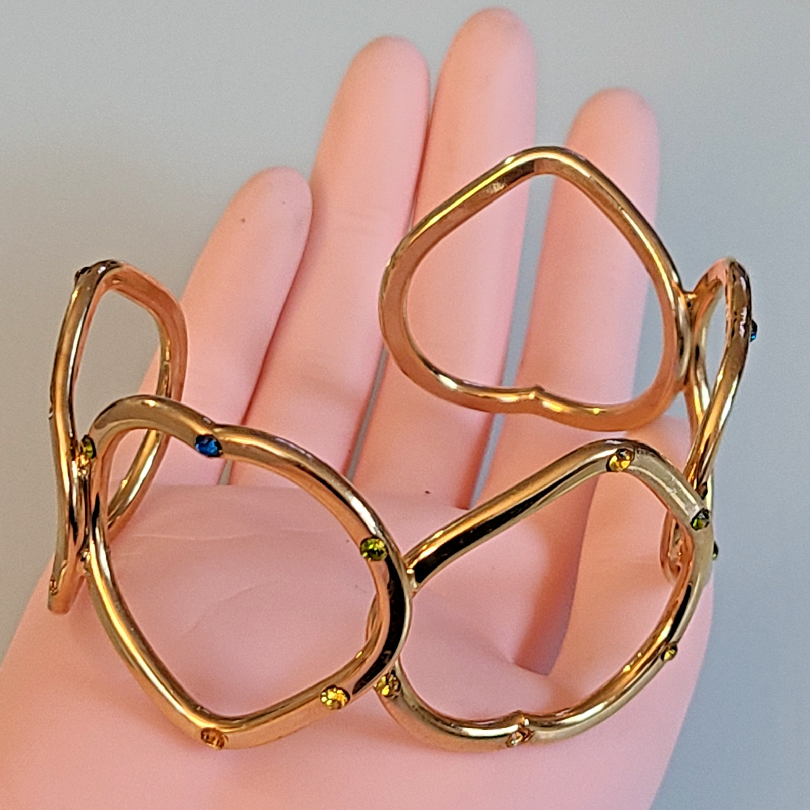 Gold-Tone Open Heart Hinged Cuff Bracelet with Multi-Color Rhinestones.