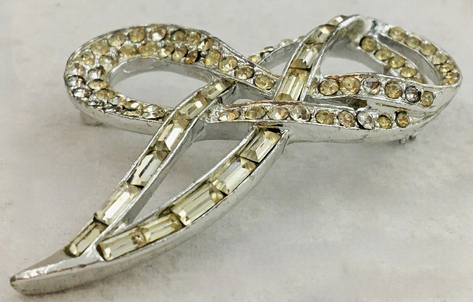 SilverTone Swirl Ribbon Brooch Pin With Clear Round with Bagette Crystals TG