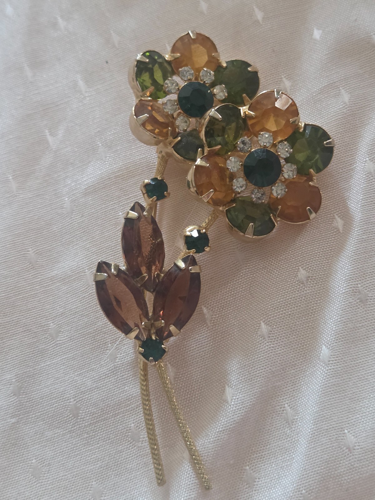 Juliana DeLizza & Elster floral brooch featuring green, amber, and yellow stones