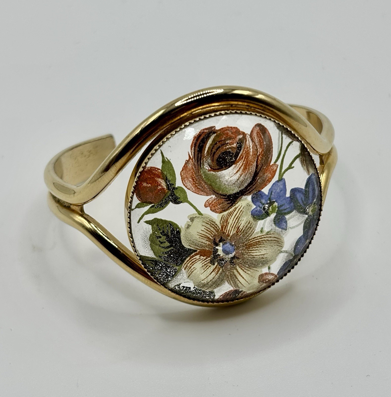 Vintage French flower medallion cuff bracelet gold-toned metal and resin.