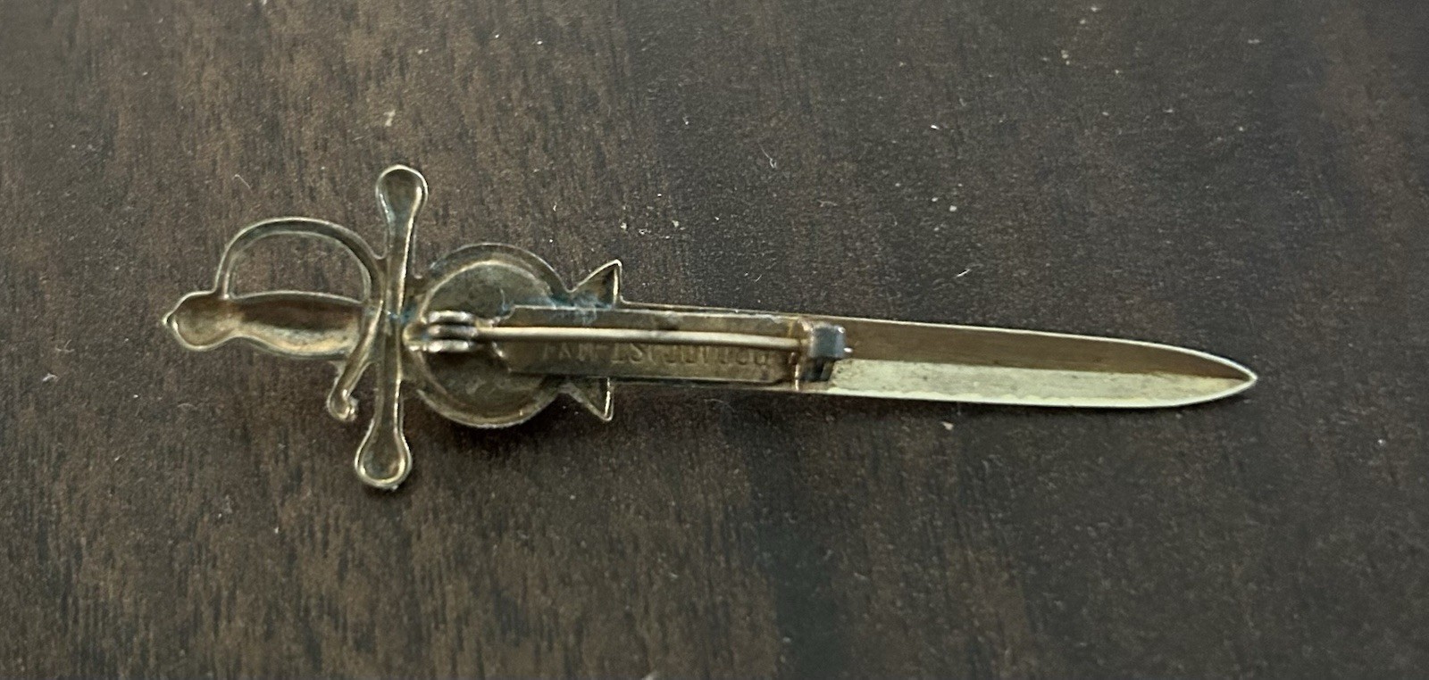 Vintage Brass Tone Sword Pin Red Round Bezel Stone Signed Broadcast