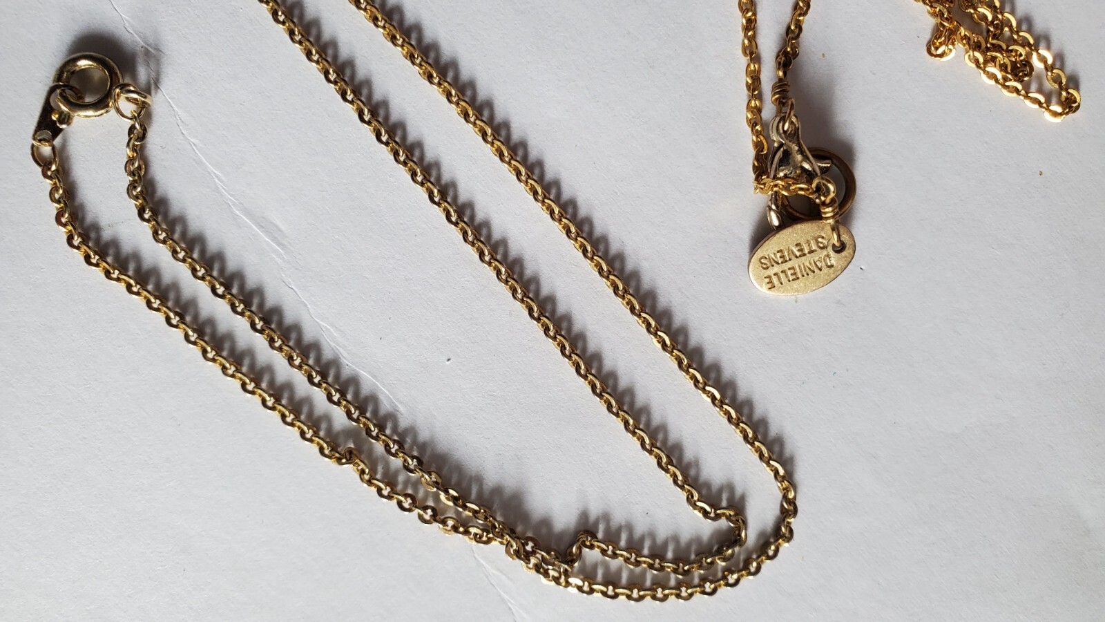 Vintage two gold tone zodiak necklaces, one designer’s Danielle Stevens