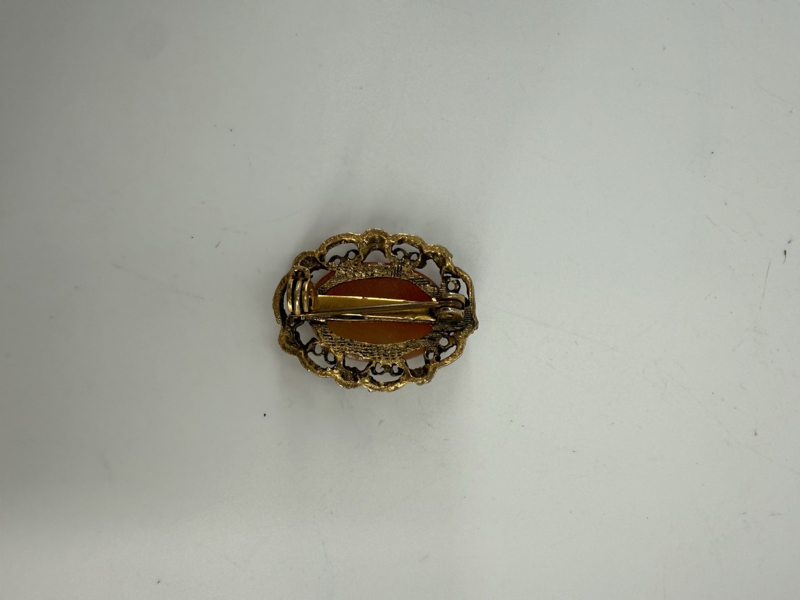 Vintage shell cameo brooch and 2 Small Pendants set in gold-tone metal.